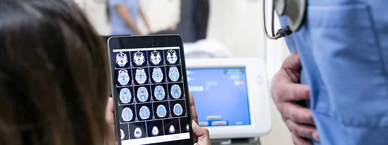 People viewing brain images on a tablet